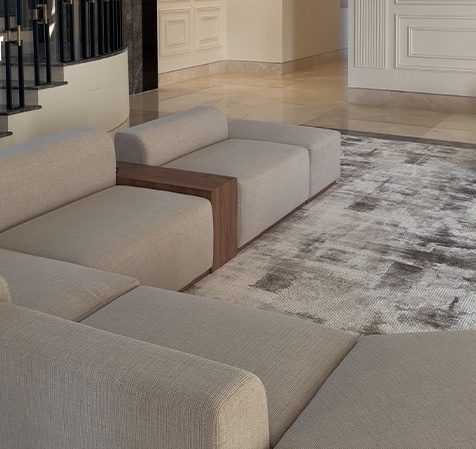 Cream modular seating on an abstract grey rug