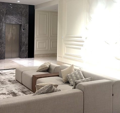 Majlis seating with grey marble and panelled walls